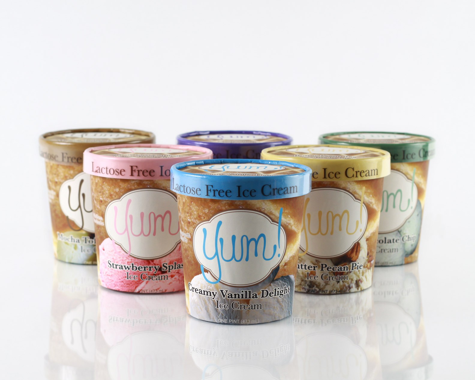 6 Pint Sized Ice Cream containers arranged in a triangle, displaying the package design for Yum! Lactose-free Ice Cream